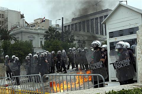 Riot police stand guard against workers and youth in Greece who are protesting the imposition of austerity measures inside the country. Europe is suffering from the world capitalist crisis. by Pan-African News Wire File Photos