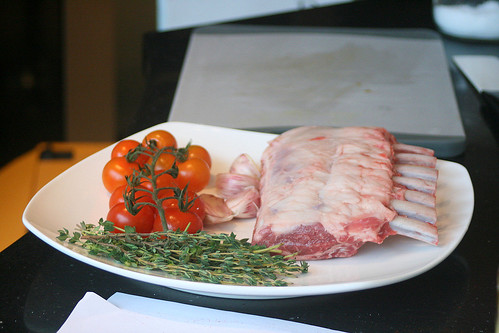 The ingredients for roast lamb - lamb rack, olive oil, pink garlic, fresh thyme, salt and pepper