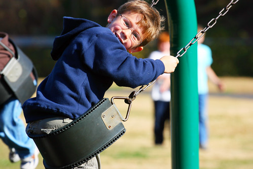 Alex having fun swinging at the park outside the zoo
