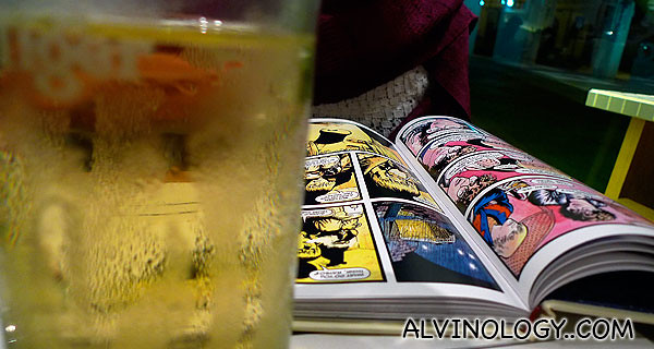 Sipping cider while reading a graphic novel