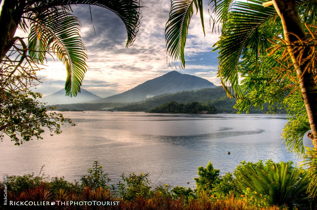 A tropical view of the Lembeh Strait, North Sulawesi, Indonesia, framed by tropical trees and shrubs