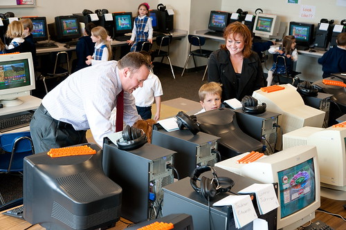 St. Simon the Apostle principal Donavan Yarnall (left) and Angela Duggan (right) check in on students in one of the computer labs.
