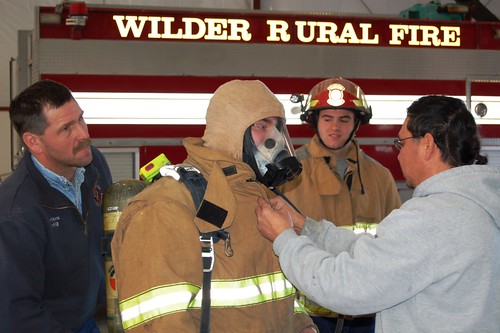 Wilder Volunteer Fire Fighters educate Job Corp Students on protective gear during Groundhog Job Shadow Day.  (L to R)Craig Lane, firefighter; John Gillette, student; Chris Henning, student; and De Enrico, firefighter.  