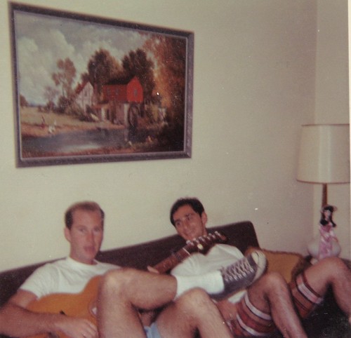 Dad on Green Couch Strumming Guitar