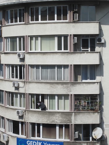 Izmiri Woman cleaning her windows.