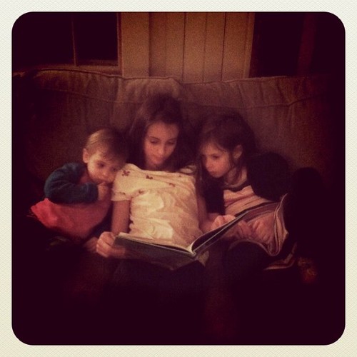 Reading to her little sisters