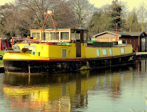 Very Bright House Boat On The Leeds Liverpool Canal. It looks like a scruffy wasp thats been in one too many fights