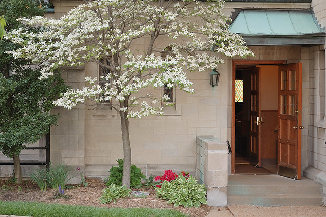 Saint Mary Magdalen Roman Catholic Church, in Brentwood, Missouri, USA - side entrance with spring flowers