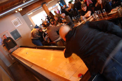 Seth Kelton (right) and Josh Grgas enjoy a round of table shuffleboard at Everybody's Brewing