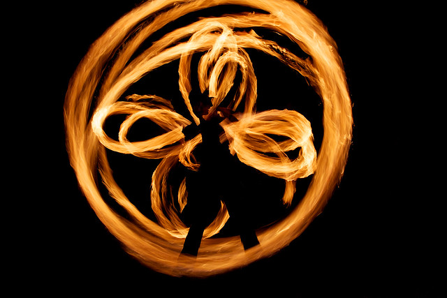 Two fire spinners silhouetted