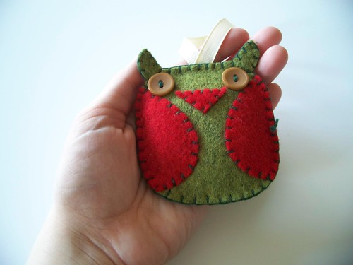 green owl ornament in hand