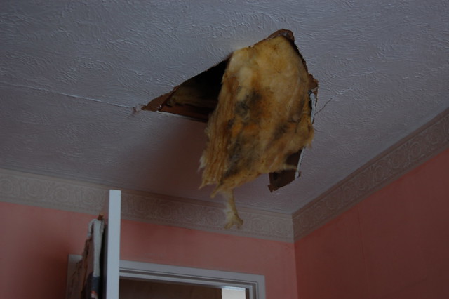 A hole from the loft into one of the rooms, where it was stood on by accident