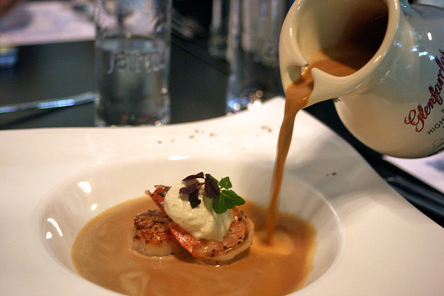 A rich seafood bouillabaisse is poured in