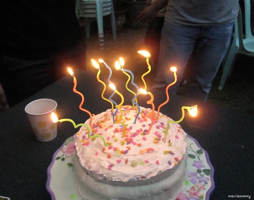 rainbow cake with rainbow sprinkles and rainbow candles