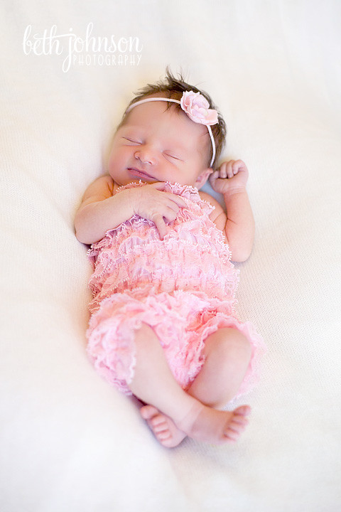 newborn baby in pink romper