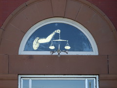 Scales of Justice or The Long Arm of the Law?