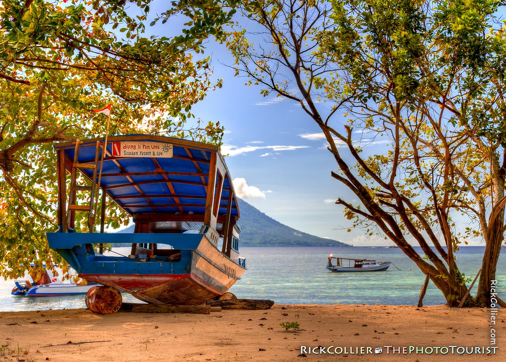 HDR Image - A dive boat pulled up on the beach at Siladen Resort and Spa