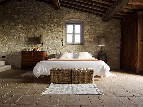 earthy bedroom with stone wall