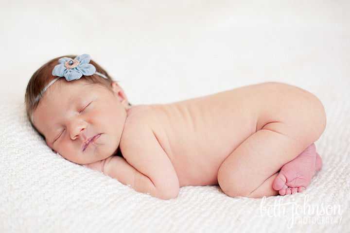 newborn baby girl in blue headband