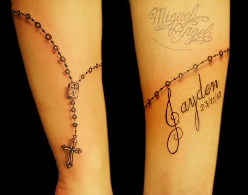 Freehand rosary beads and name tattoo