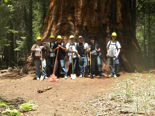 Members of the Central California Consortium stand in front of a massive tree, part of the natural resources they help sustain. (Photo by Central California Consortium)