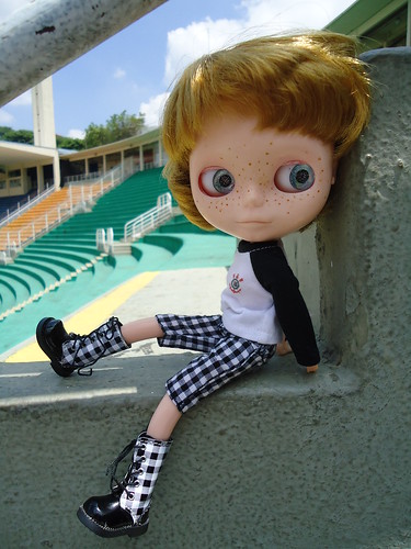 picture of doll sitting in empty stadium