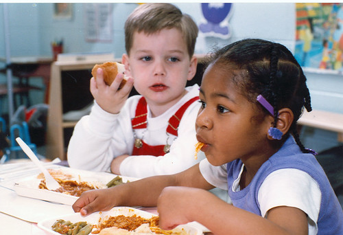 Two elementary school students enjoy a safe and nutritious meal through USDA’s National School Lunch Program.  