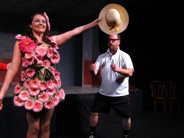Savannah tries to learn to hold her hat like a champion from Don and Percy (Bryan Krasner), the Pageant Masters.