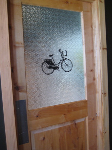 bike on women's bathroom door