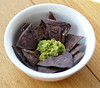 Baked purple tortilla chips with guacamole.