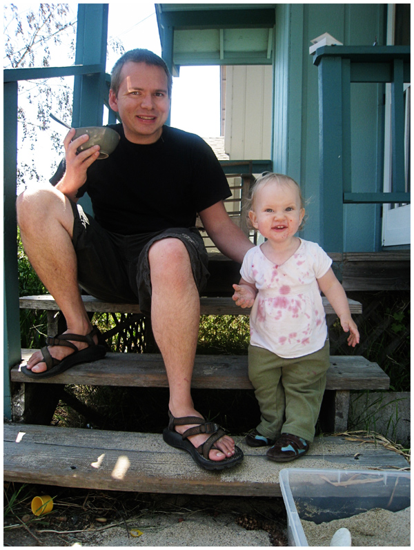 Father and daughter enjoying blackberries on the porch steps