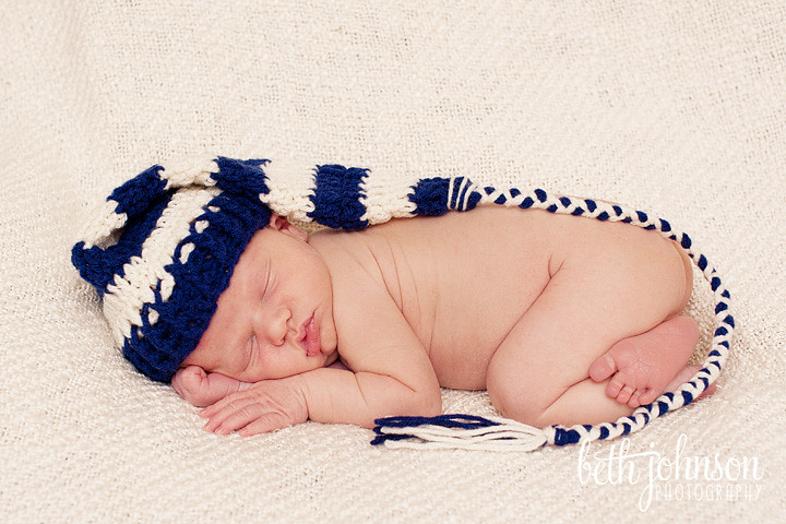 newborn baby boy in navy and white elf hat