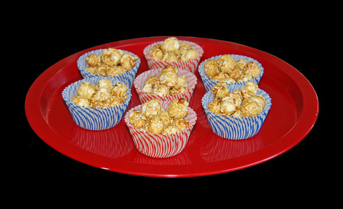 carmel corn in stripped red and blue cupcake liners for 4th of July
