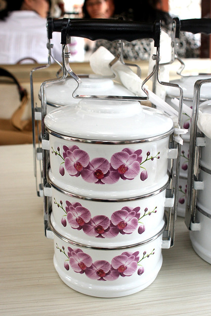 You get to bring this little baby home! This year's tiffin carrier is white with orchids
