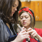 Students working on a flute.