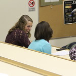 Students discuss a presentation in Phillips Lecture Hall.