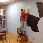 Students painting pictures on the wall of the math lounge