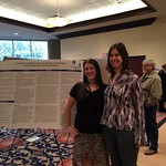 A student and a faculty member pose with the student's capstone poster.