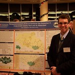 A man posing with his research poster.