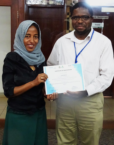 Appolinaire Djikeng presents certificate to Zufan Bedewi from Addis Ababa University