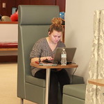 A student typing a paper in the library.