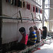 People weaving a carpet at Hotan silk factory