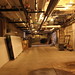 Overhead pipes in main basement corridor