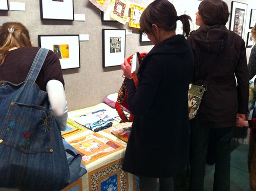 People checking out quilts + projects
