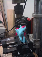My Little Pony poised under the drill press