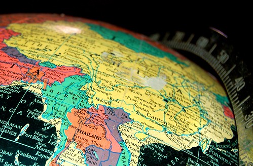 Shot of a globe in rainbow colors, focused on a yellow map of China