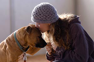 Oscar the Vicktory dog and Carissa the Best Friends caregiver share a moment