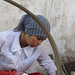 Girl spins freshly extracted silk - Hotan, Xinjiang