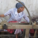 Girl spins freshly extracted silk - Hotan, Xinjiang