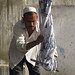 Uyghur man twisting silk to remove excess water - Hotan